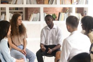 a group of people sits in a circle and learns about the Types of Therapy