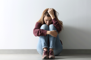 a woman struggles with unpleasant and severe alcohol withdrawal symptoms