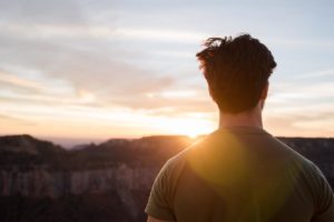 a person overlooking a sunset wonders about being sober curious