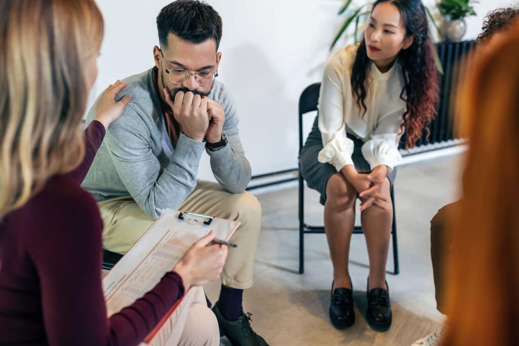 a group of people sit in chairs and talk about reasons to break the cycle of drug addiction