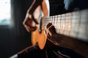 someone plays guitar to show how music therapy improves mental health