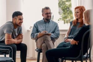 a group of people sit in chairs and talk about a successful marijuana treatment