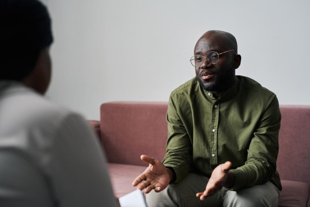 a person sits in therapy to maintain long term sobriety from alcohol