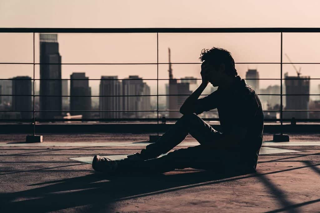 a person outside on a roof overlooking a city showing signs of heroin overdose