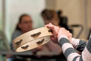 Patient holding a musical instrument answers the question, "Does music therapy help depression?"