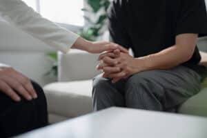 a person comforts a patient to show how PTSD treatment can help