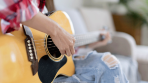 someone plays guitar to show the benefits of music therapy
