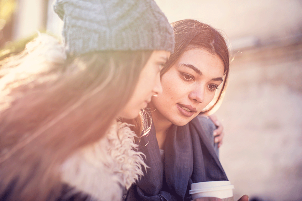 a person wraps their arms around their friend after learning how to help a friend with prescription drug addiction