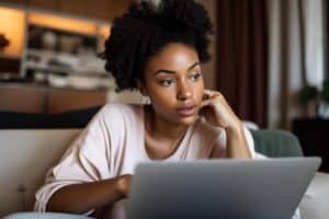 a person sits at a laptop and looks up tips on creating a relapse prevention plan