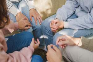 a group of people sit in a circle after they find a substance abuse treatment center in loveland co