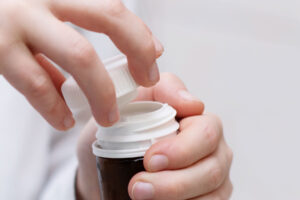 a person opens a prescription bottle while identifying prescription drug abuse